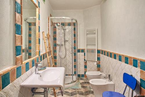 a bathroom with a sink and a shower and a toilet at Alla Scala 1746 in Siena