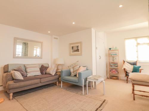 a living room with a couch and a chair at Searles in Lympstone