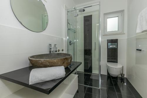 a bathroom with a sink and a toilet at Sun Villa in Dramalj