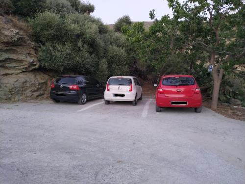 a group of three cars parked in a parking lot at Silver view in Batsi