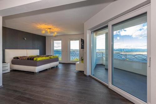 a bedroom with a bed and a balcony at Sun Villa in Dramalj