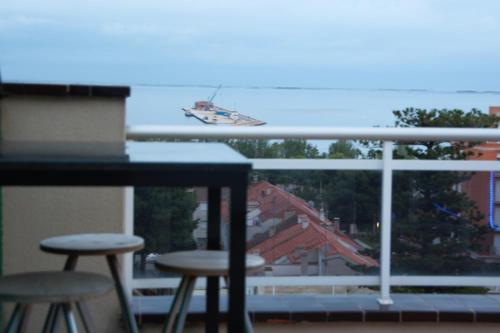 a view of a boat in the water from a balcony at Ático de lujo con vistas al mar in Sant Carles de la Ràpita