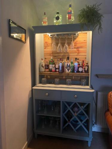 a cabinet with a sink in a room at Mingo Cottage in Bewdley