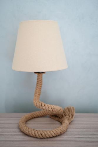 a nautical rope lamp with a rope shade on a table at Villa La Pagaia Sorrento Coast in Vico Equense