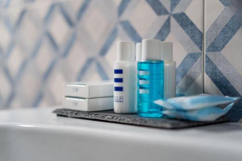 a bathroom counter with two bottles of soap and a mirror at Villa La Pagaia Sorrento Coast in Vico Equense