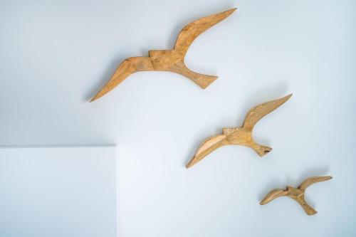 a group of three birds hanging on a wall at Villa La Pagaia Sorrento Coast in Vico Equense