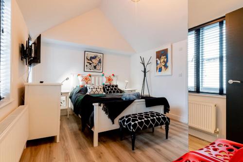 a bedroom with two beds with black and white at Large Modern 2 Bedroom Queen Street Apartment in Norwich