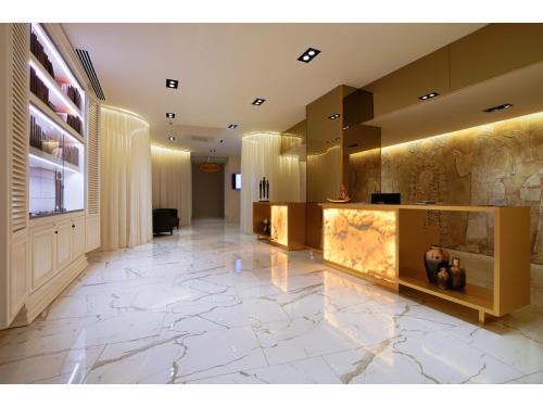 a lobby with a large marble tile floor and a lobby at Limak Cyprus Deluxe Hotel in Iskele