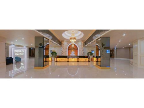 a lobby of a building with a sign on the floor at Limak Cyprus Deluxe Hotel in Iskele
