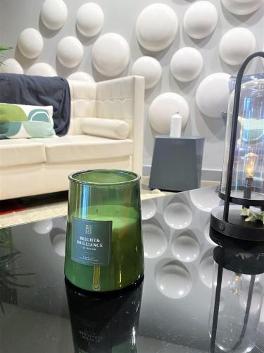 a candle on a table in a living room at ibis Styles Lyon Sud Vienne in Chasse-sur-Rhône