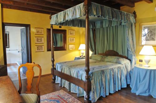 a bedroom with a canopy bed in a room at Hotel Torre di San Martino in Gazzola Di Rivalta