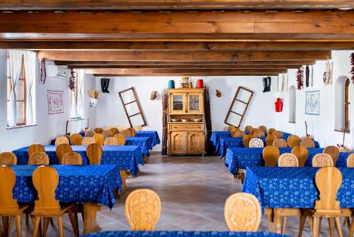 a room with blue tables and chairs and a podium at Gastland M1 Hotel & Conference Center in Páty
