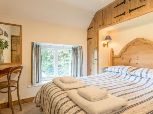 מיטה או מיטות בחדר ב-Dorothy's Cottage