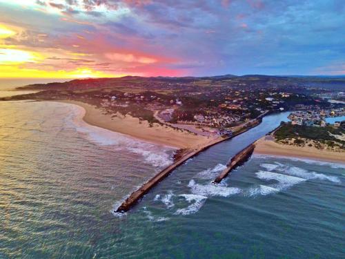 an aerial view of a beach at sunset at Settler Sands - Holsboer Vacations in Port Alfred