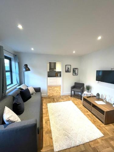 a living room with a couch and a table at Prosper House Apartment 5 in Norwich
