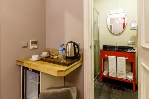 a small bathroom with a table and a mirror at La Porte de Taksim in Istanbul