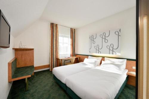 Postel nebo postele na pokoji v ubytování das seidl - Hotel & Tagung - München West