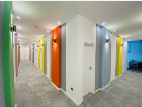 a hallway with brightly colored walls in a building at Osten Art Hotel in Skopje