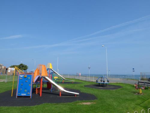 a playground with a slide and a slidesktop at Roma in Rhôs-on-Sea