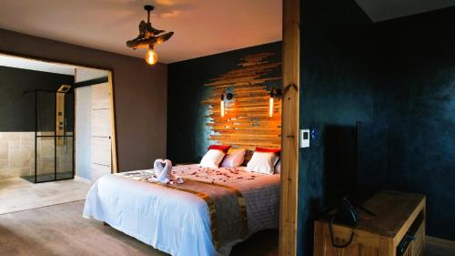 a bedroom with a bed and a wooden wall at Villa Occitana in Calvisson