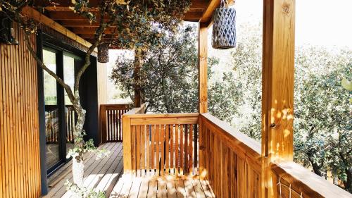 a porch with a wooden fence and trees at Villa Occitana in Calvisson
