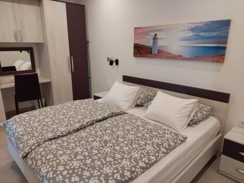 a bedroom with a bed with a lighthouse on the wall at Apartment Sky View in Cres