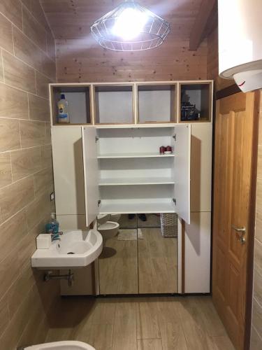 a bathroom with a white sink and a toilet at Vila Gjiri Lalzit in Durrës