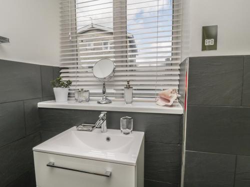 a bathroom with a sink and a mirror at 11 Camden Building in Kendal