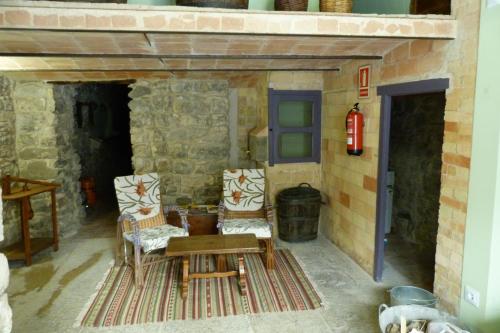 a room with two chairs and a table and a fire hydrant at Ca naleix verdu in Verdú