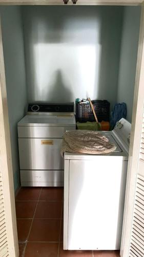 a small kitchen with a stove and a counter top at Brenda alicia in Puerto Peñasco