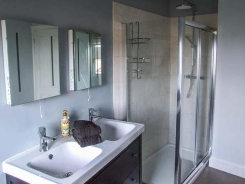 a bathroom with a sink and a shower at Woodland Cottage in Malvern Wells