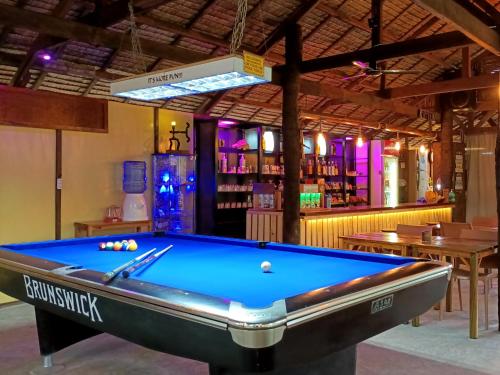 a pool table in a room with a bar at Archery-Asia Nipa Huts Moalboal in Moalboal