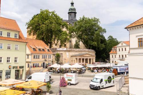 a city square with a large building with a tower at Pension Schlossblick in Sondershausen