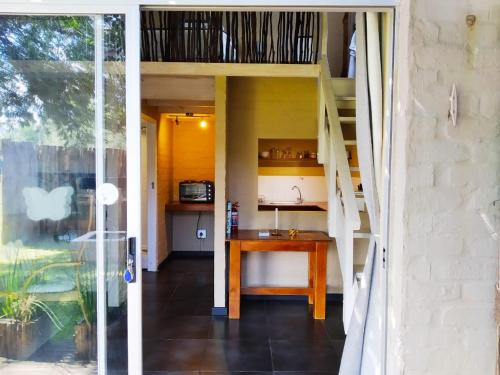 a dining room with a table and a staircase at Green Hills Forest Lodge in The Crags