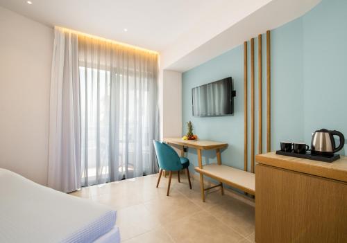 a hotel room with a bed and a table and a desk at M City Hotel in Chania Town
