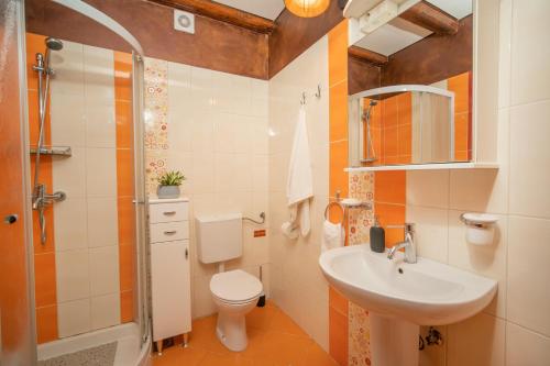 a bathroom with a sink and a toilet and a shower at House Luce in Krapan