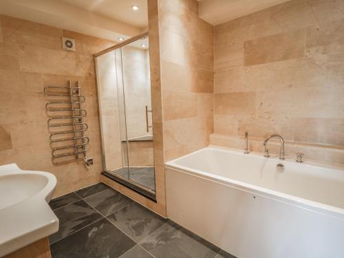 a bathroom with a tub and a shower and a toilet at Boavista in Carnforth