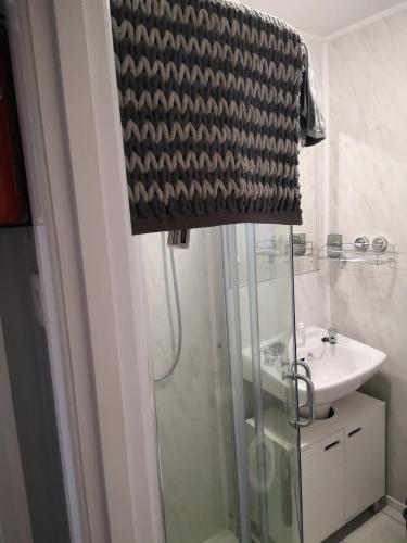 a bathroom with a shower and a sink at 238b South shore in Bridlington