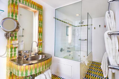 a bathroom with a sink and a shower at The Tony Hotel South Beach in Miami Beach