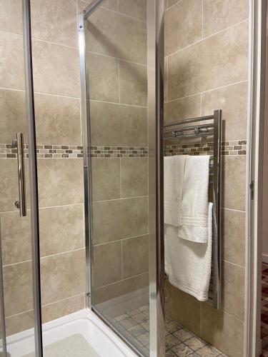 a shower with a glass door in a bathroom at Scone Arms Hotel in New Scone
