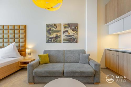 a living room with a couch and a bed at TATRA SUITES Luxury Studio C410 in Smokovce