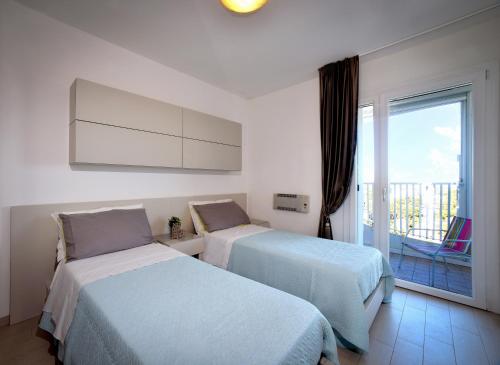 A bed or beds in a room at Residence Colorado Deluxe