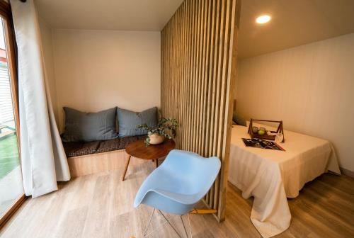 a bedroom with a bed and a blue chair at Tres Estrellas in Gavà