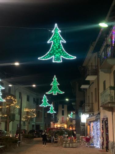 two green christmas trees are hanging from the ceiling at Casa Colmegna mit traumhaften See- und Bergblick in Luino