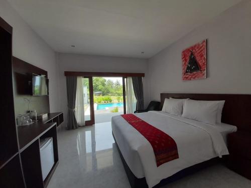 a hotel room with a bed and a television at Tree Tops Mandalika in Kuta Lombok