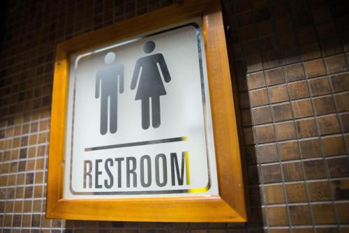a restroom sign on the wall of a restroom at The Sweet Luxembourg Garden in Paris