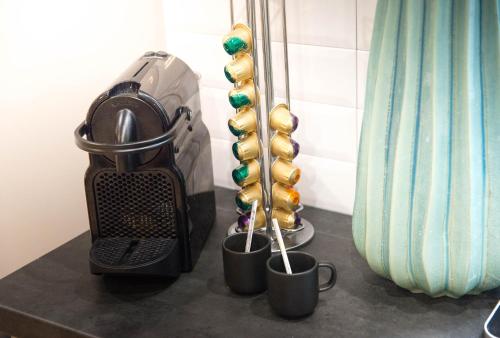 a table with some cups and balls in a room at The Sweet Luxembourg Garden in Paris