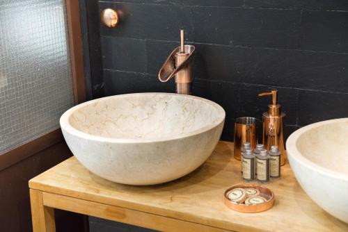 a bathroom with two sinks on a wooden table at The Sweet Luxembourg Garden in Paris