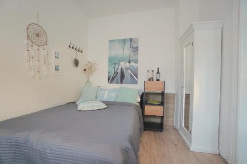 a bedroom with a bed in a white room at Ferienwohnung Koje in zentraler Lage zum Schleswiger Dom in Schleswig