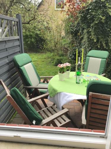 a patio with a table and chairs on a deck at Ferienwohnung Seestern in zentraler Lage von Eckernförde in Eckernförde